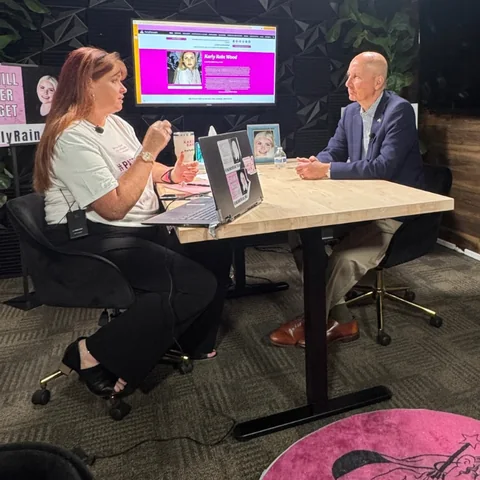 A podcast interview with Senator Pete Ricketts in a studio decorated with Karly Rain remembrance signs.